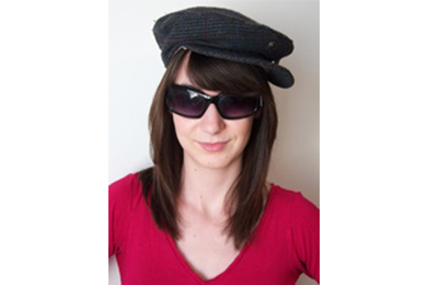 Faceshot of a student with sunglasses and a hat