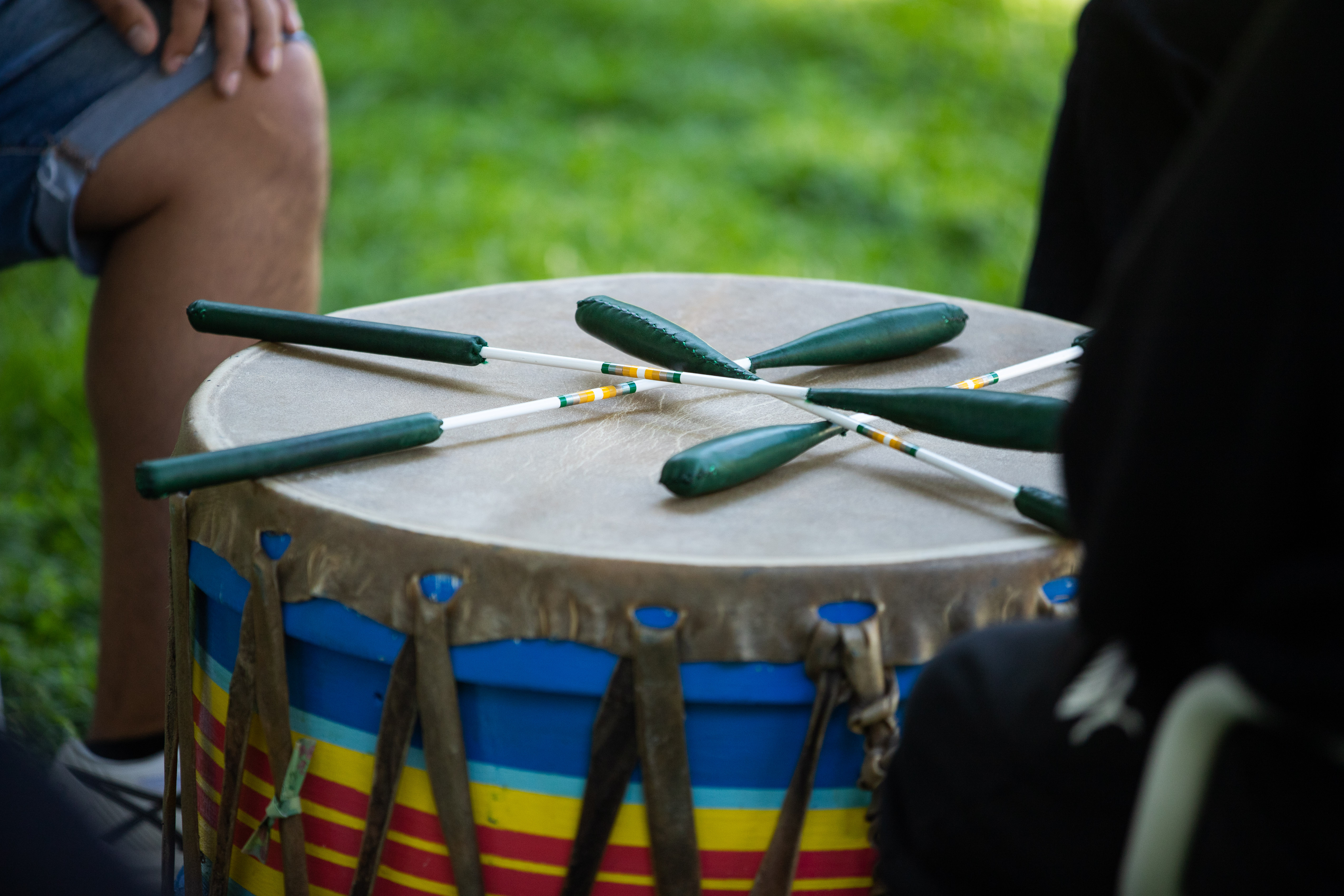 Drum beaters on top of an Indigenous drum