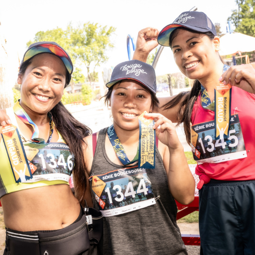 3 female athletes holding up ribbons