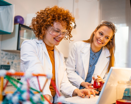 Two female students doing research in lab