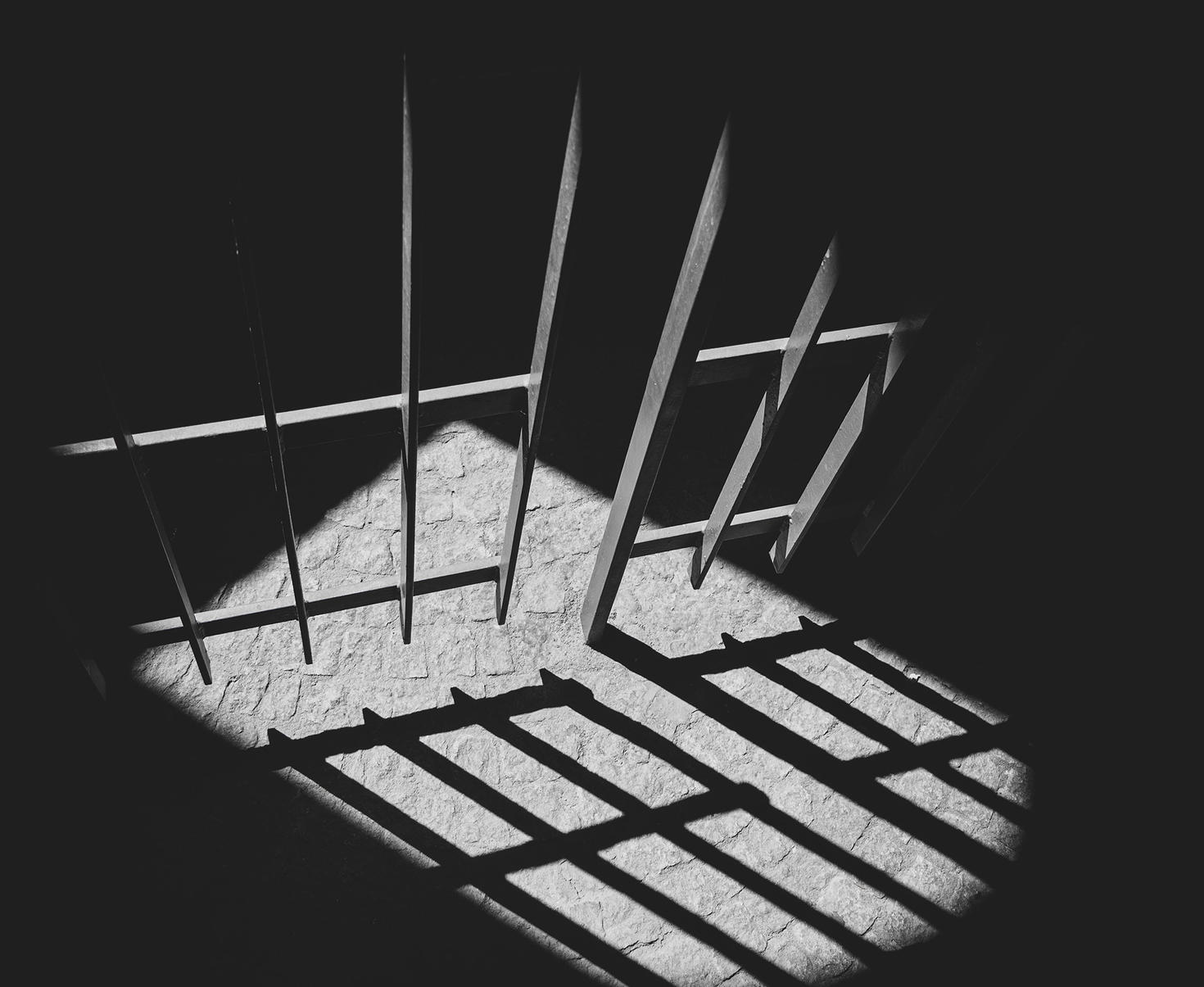 Prison bars casting a shadow